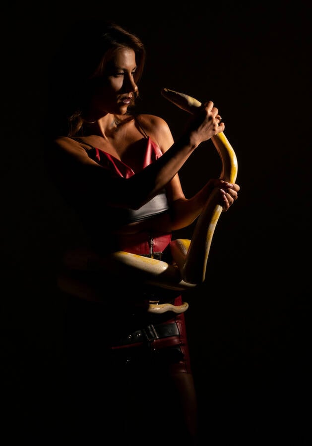photographer Alan Tog theme modelling photo. lovely model posing with a yellow and white 15 foot snake.