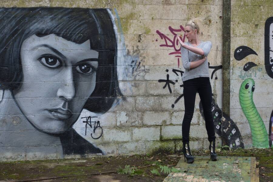photographer Alan Tog portrait modelling photo. another in the derelict factory this portrait on the wall looks as if she is scowling her daughter the model so she says talk to the hand.