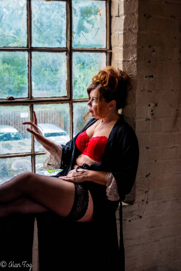 photographer Alan Tog lingerie modelling photo. capture of this lovely model sat on the window sill wearing red lingerie set.