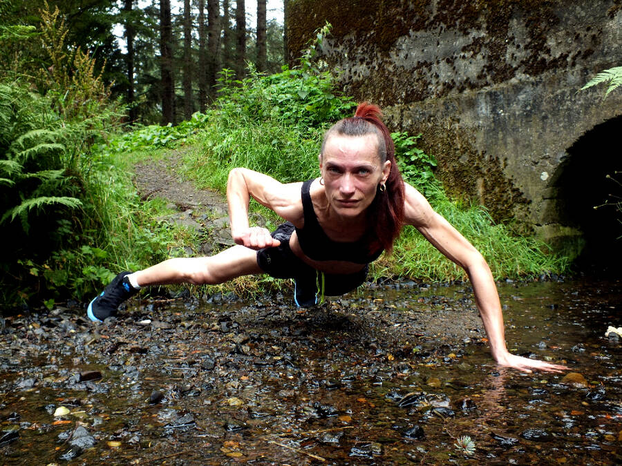 photographer johnyrebel fitness modelling photo. muscle gina in the forest creek.